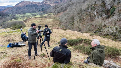 Film crew and presenter Jules Hudson on a hill in Snowdonia, North Wales